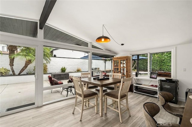 sunroom / solarium with lofted ceiling with beams and a healthy amount of sunlight