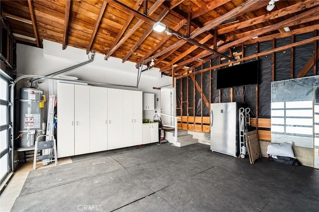 garage with strapped water heater and fridge