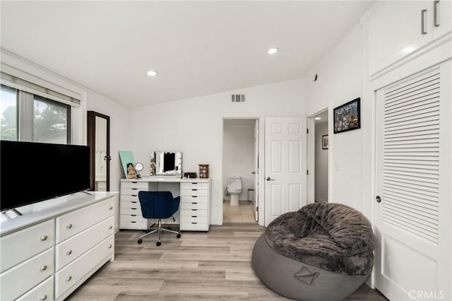 office with light hardwood / wood-style floors and lofted ceiling