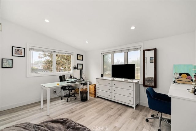 office area with light hardwood / wood-style floors and vaulted ceiling