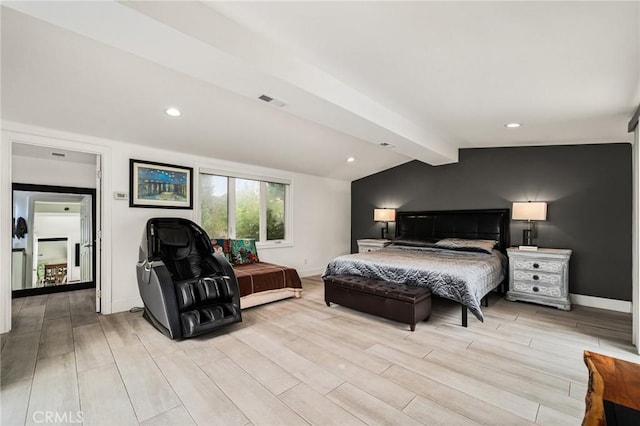 bedroom with lofted ceiling with beams and light hardwood / wood-style flooring