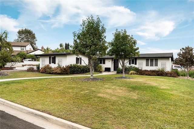 ranch-style home featuring a front yard