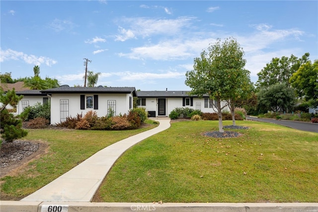 ranch-style home with a front yard