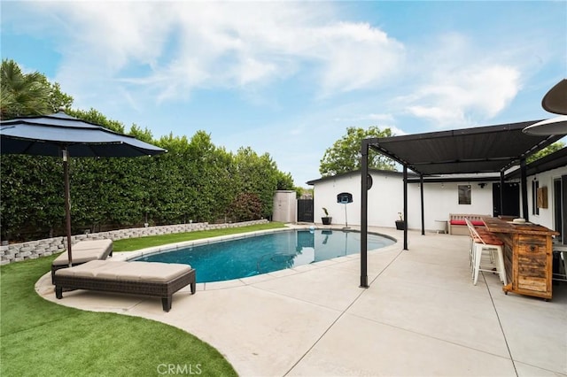 view of pool featuring a bar and a patio