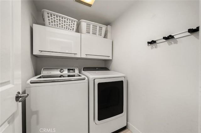 laundry area featuring cabinets and independent washer and dryer