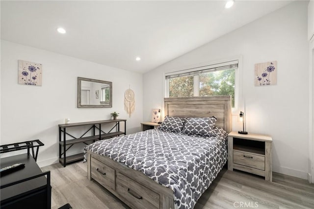 bedroom featuring vaulted ceiling and light hardwood / wood-style flooring