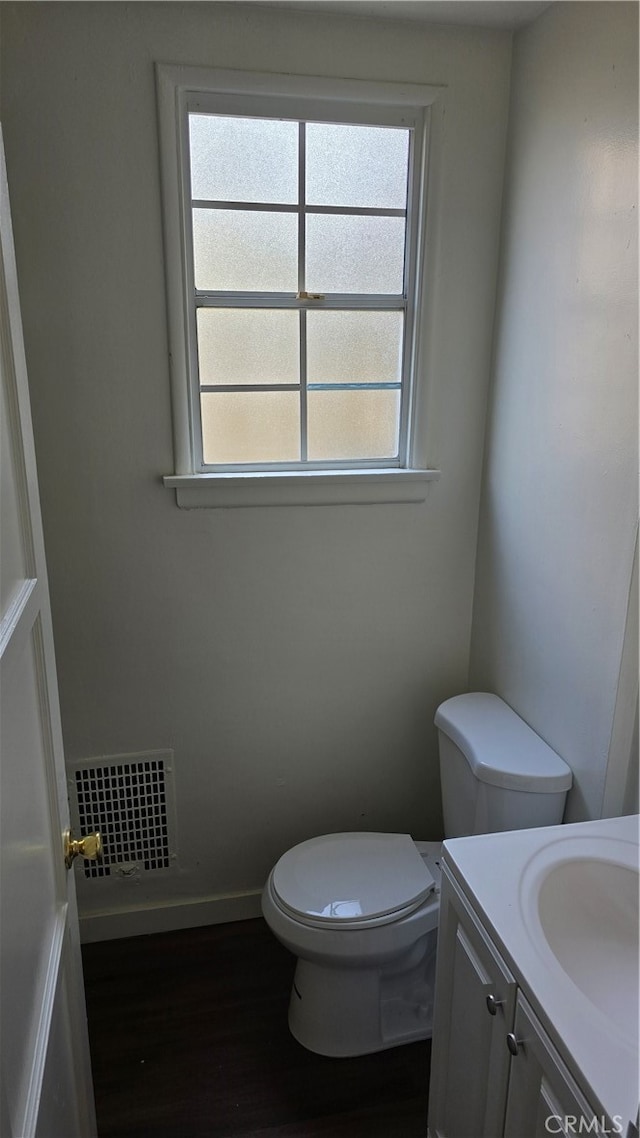 bathroom with vanity, hardwood / wood-style flooring, and toilet