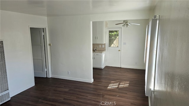 spare room featuring ceiling fan and dark hardwood / wood-style flooring