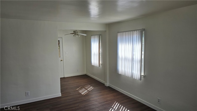 spare room with ceiling fan and dark hardwood / wood-style flooring