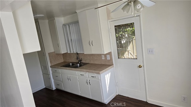 kitchen with white cabinetry, sink, and dark hardwood / wood-style flooring