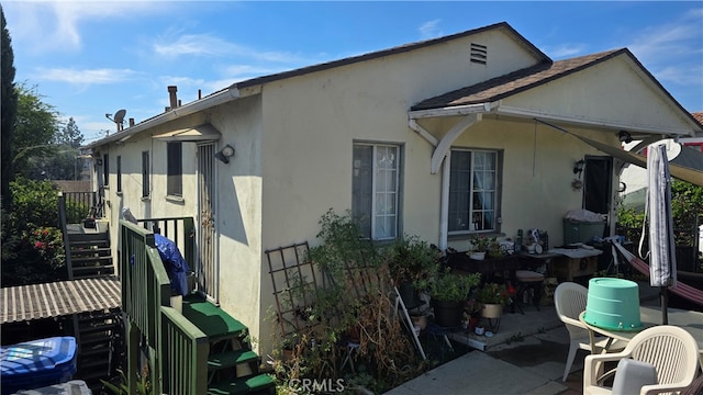 view of side of property with a patio