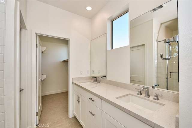 bathroom with vanity, a shower with shower door, and tile patterned floors