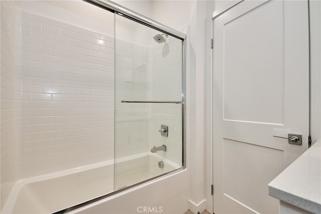 bathroom featuring shower / bath combination with glass door