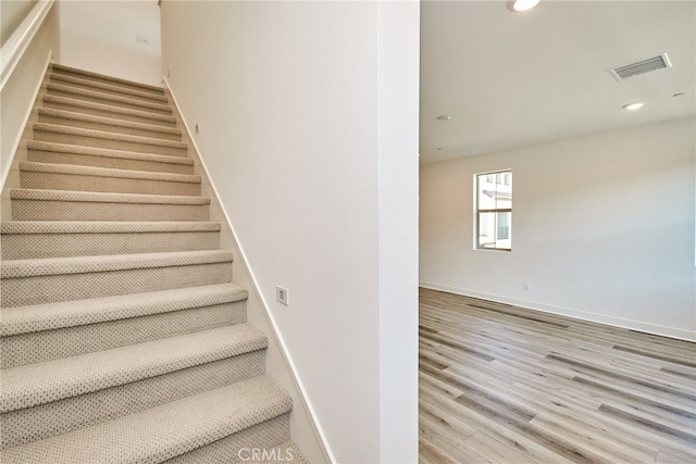 stairway with wood-type flooring