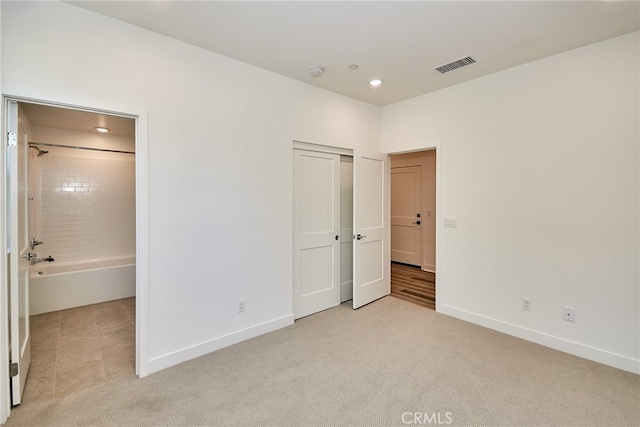 unfurnished bedroom with light colored carpet