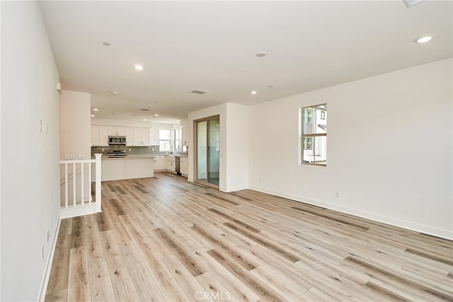 unfurnished living room featuring light hardwood / wood-style floors