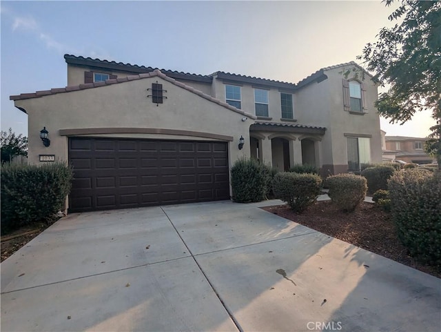 mediterranean / spanish-style house with a garage