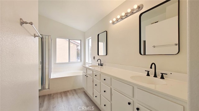 bathroom featuring hardwood / wood-style floors, vanity, lofted ceiling, and independent shower and bath