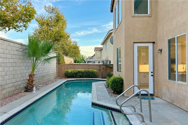 view of pool featuring a patio area, a fenced backyard, and a fenced in pool