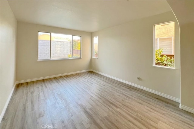 unfurnished room featuring wood finished floors and baseboards