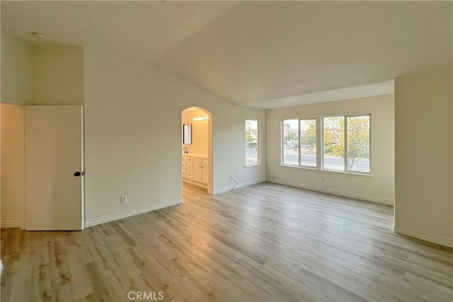 unfurnished room featuring light hardwood / wood-style flooring and vaulted ceiling