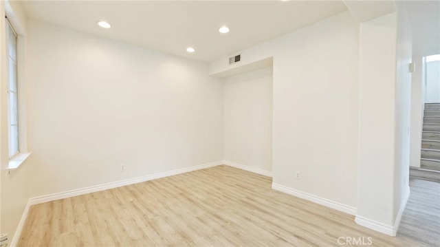 unfurnished room with light wood-type flooring