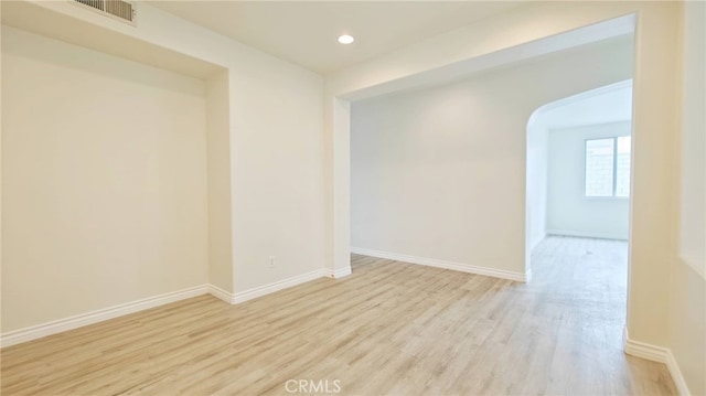 spare room featuring light wood-type flooring