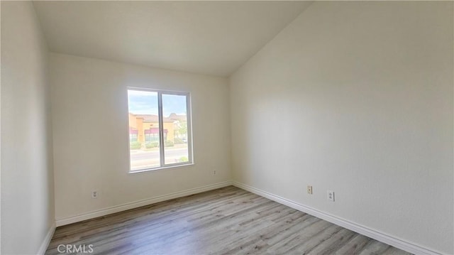 empty room with wood finished floors and baseboards