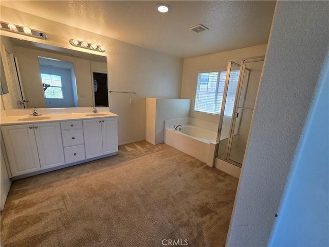 37515 Ruby Red Ln, Palmdale, CA 93551 - full bathroom featuring healthy amount of natural light, a bath, double vanity, a stall shower, and a textured ceiling
