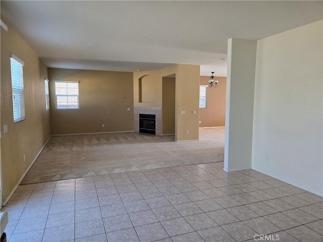 37515 Ruby Red Ln, Palmdale, CA 93551 - unfurnished living room with a tile fireplace, plenty of natural light, and baseboards
