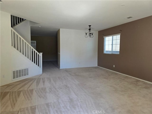 37515 Ruby Red Ln, Palmdale, CA 93551 - empty room with stairway, carpet, a chandelier, and baseboards