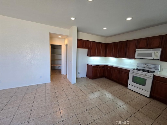 37515 Ruby Red Ln, Palmdale, CA 93551 - kitchen featuring white appliances, light countertops, light tile patterned floors, and recessed lighting