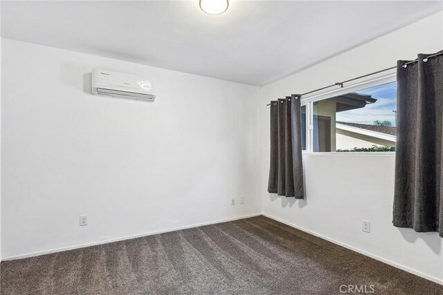 carpeted empty room featuring a wall mounted AC