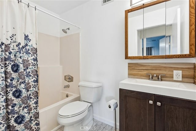 full bathroom with vanity, shower / bath combo with shower curtain, and toilet