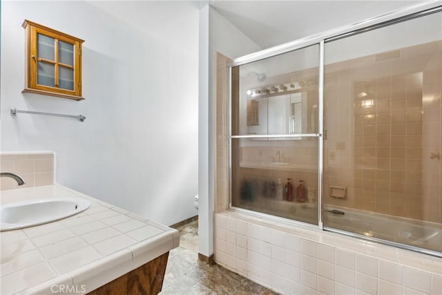 full bathroom with vanity, enclosed tub / shower combo, and toilet