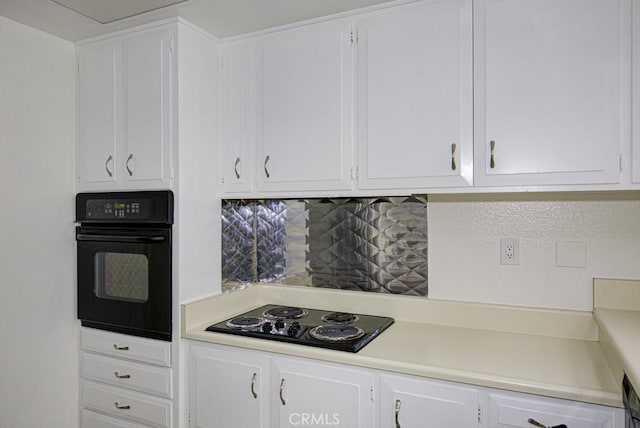 kitchen with white cabinets, decorative backsplash, and black appliances