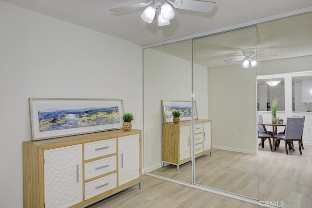 interior space featuring hardwood / wood-style floors, ceiling fan, a textured ceiling, and a closet