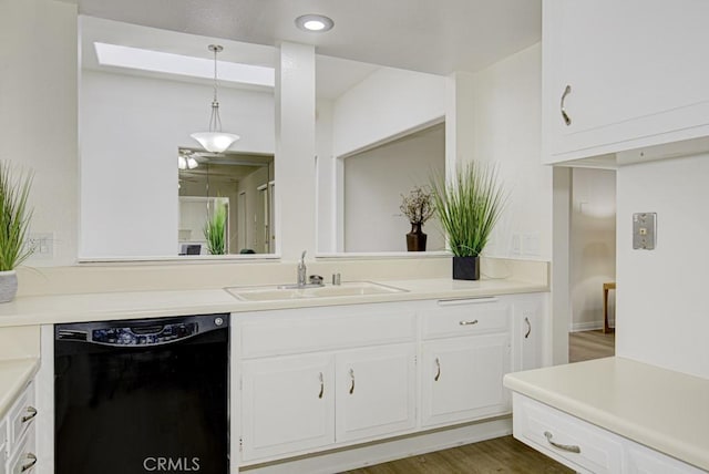 kitchen with dark hardwood / wood-style flooring, sink, dishwasher, white cabinetry, and hanging light fixtures