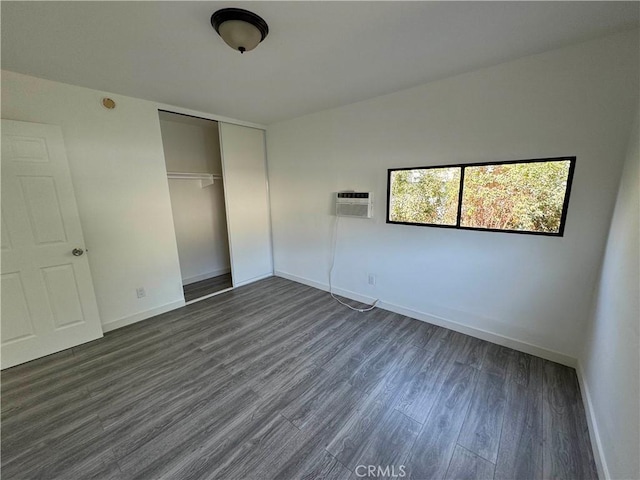 4812 E Seldner Ave, Los Angeles, CA 90032 - unfurnished bedroom featuring dark wood-style flooring, a closet, and a wall unit AC
