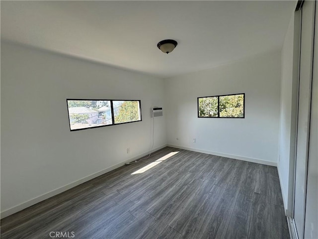 4812 E Seldner Ave, Los Angeles, CA 90032 - spare room featuring healthy amount of natural light, dark wood-style floors, and a wall unit AC
