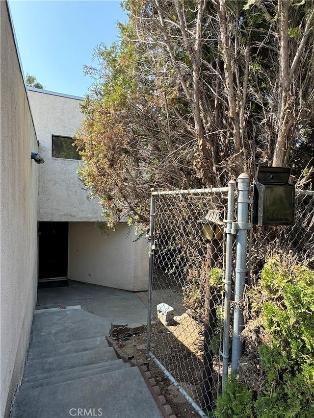 4812 E Seldner Ave, Los Angeles, CA 90032 - view of side of property with stucco siding and a gate