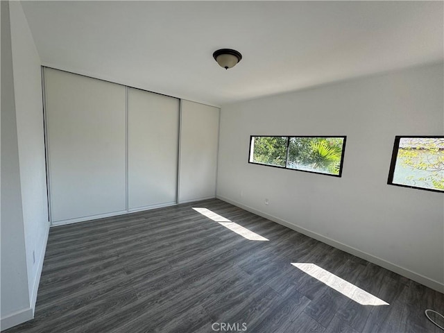 4812 E Seldner Ave, Los Angeles, CA 90032 - unfurnished bedroom featuring dark wood-style flooring and a closet