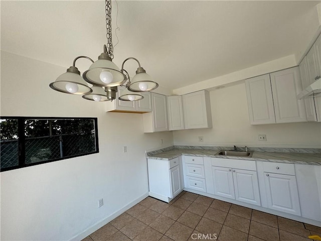4812 E Seldner Ave, Los Angeles, CA 90032 - kitchen with tile patterned floors, white cabinetry, and a chandelier