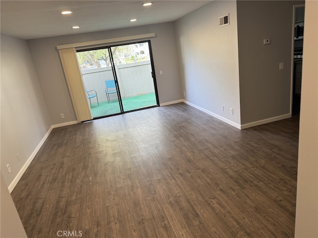 empty room with dark hardwood / wood-style floors