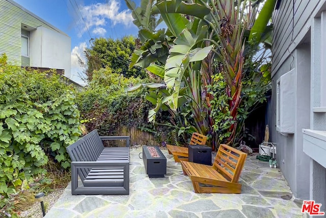 view of patio featuring an outdoor living space with a fire pit