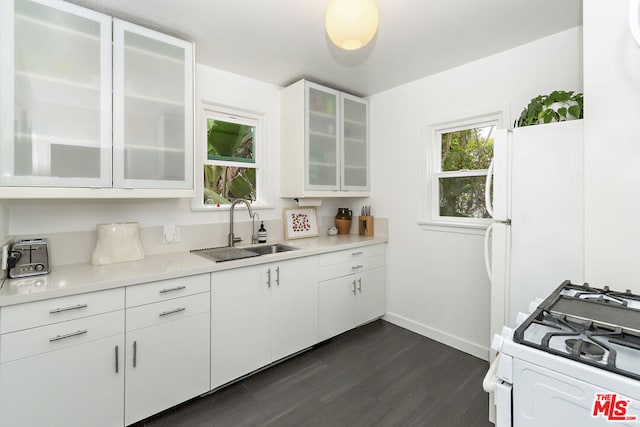 kitchen featuring dark hardwood / wood-style floors, white cabinetry, white appliances, and sink