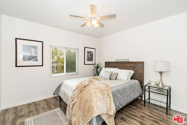 bedroom with dark hardwood / wood-style floors and ceiling fan