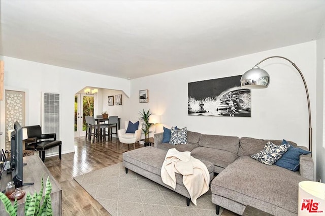 living room featuring hardwood / wood-style floors and a notable chandelier