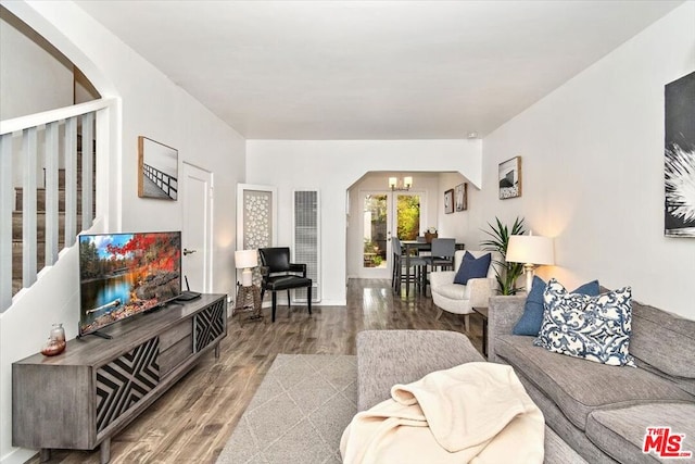 living room featuring a chandelier and wood-type flooring