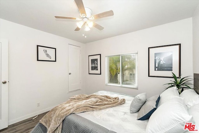 bedroom with ceiling fan and wood-type flooring